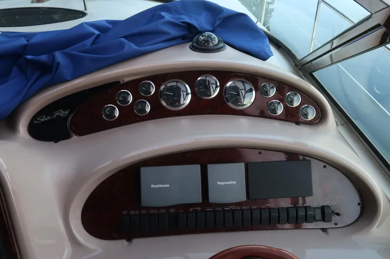 Slide: The Image of Control panel of 2002 Sea Ray 410 Sundancer with gauges and navigation equipment. - 16