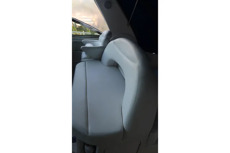 Slide: The Image of Interior seating of 2002 Sea Ray 410 Sundancer boat, featuring plush, light-colored upholstery. - 19