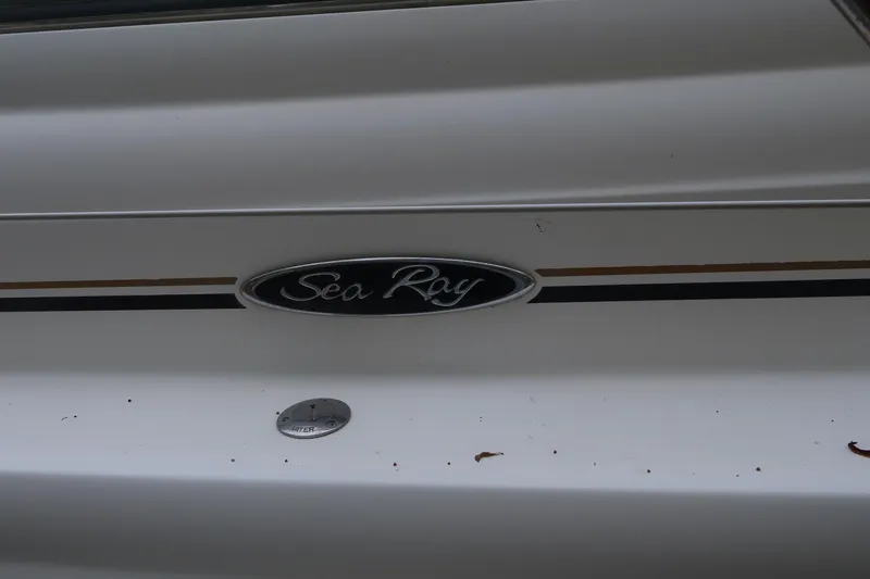 Slide: The Image of 2002 Sea Ray 410 Sundancer boat emblem on white surface. - 25