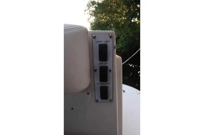 Slide: The Image of Control panel on a 2002 Sea Ray 410 Sundancer boat, featuring cockpit lights and switches. - 27