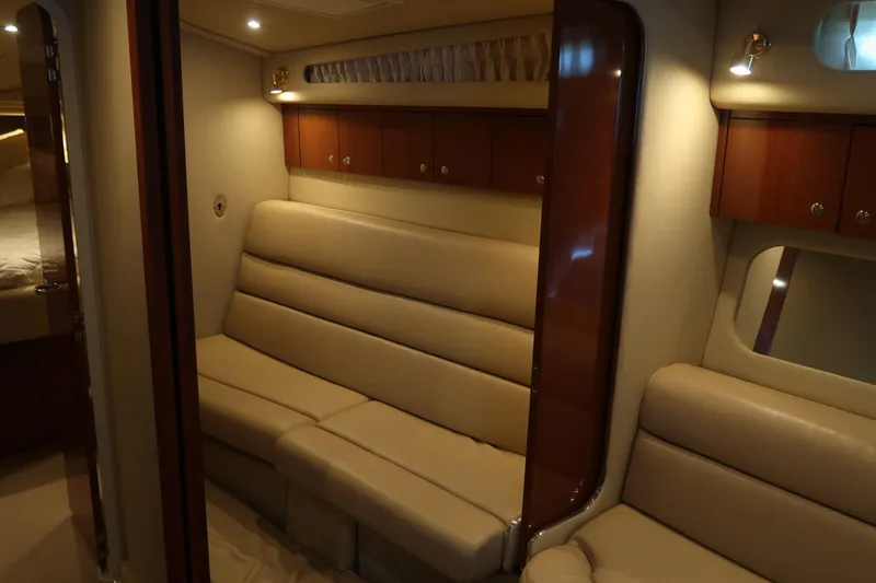 Slide: The Image of Luxurious interior of 2002 Sea Ray 410 Sundancer yacht with beige seating and wooden cabinets. - 29