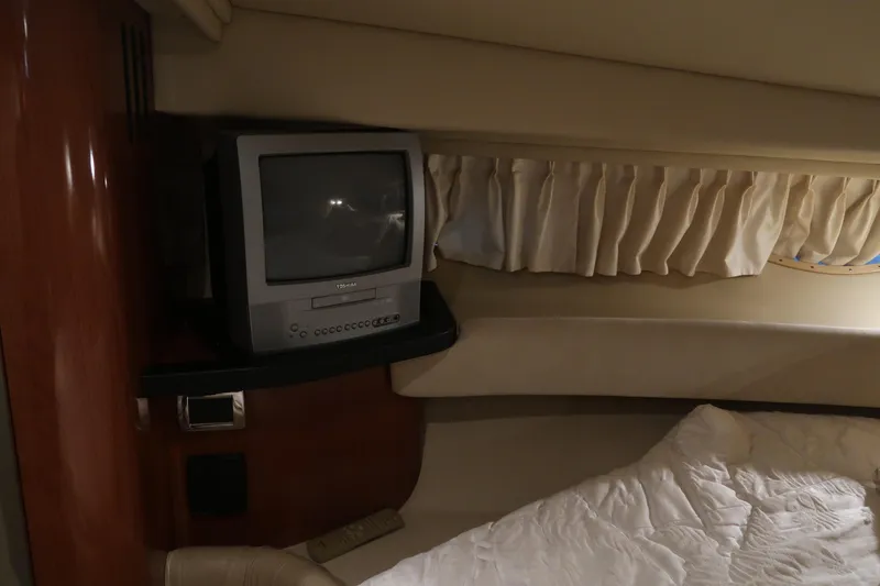 Slide: The Image of 2002 Sea Ray 410 Sundancer cabin with TV and cozy bedding. - 35