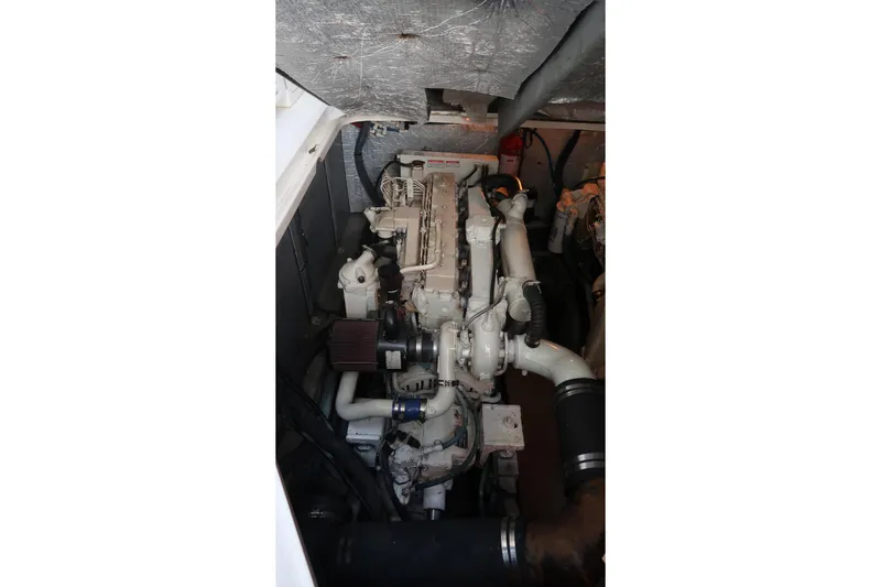 Slide: The Image of Engine compartment of a 2002 Sea Ray 410 Sundancer boat, showcasing mechanical components. - 39