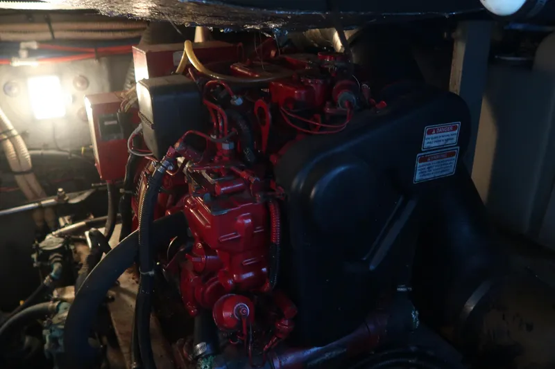 Slide: The Image of Engine room of 2002 Sea Ray 410 Sundancer with red engine components. - 43