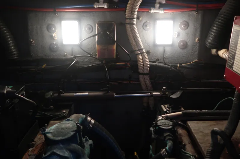 Slide: The Image of Engine room of a 2002 Sea Ray 410 Sundancer with illuminated panels and visible wiring. - 45