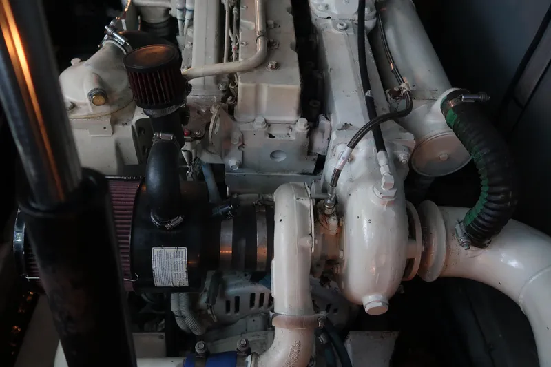 Slide: The Image of Engine compartment of a 2002 Sea Ray 410 Sundancer boat, showcasing mechanical components. - 51