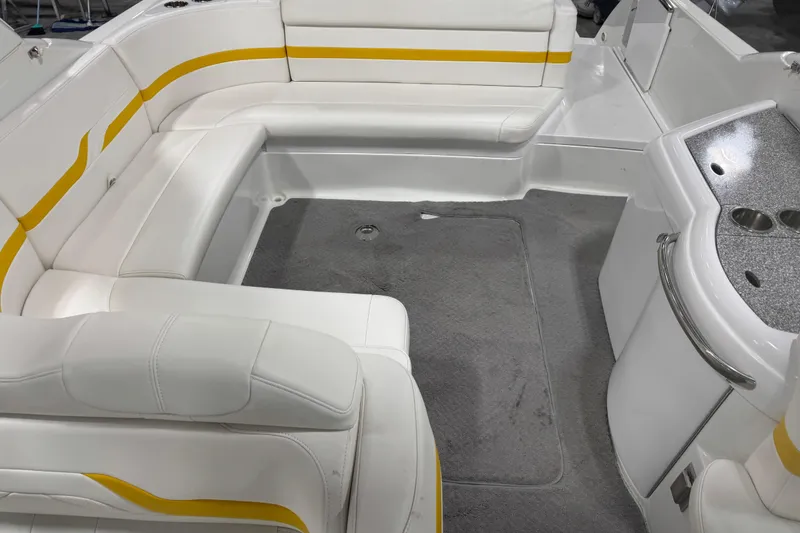 Slide: The Image of 2005 Formula 330 Sun Sport boat interior with white and yellow seating, gray carpet, and kitchenette. - 10