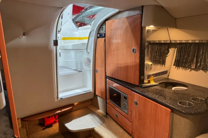 Slide: The Image of Interior of 2005 Formula 330 Sun Sport boat with kitchenette and seating area. - 11
