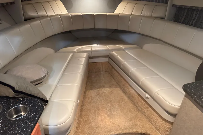 Slide: The Image of 2005 Formula 330 Sun Sport interior with beige leather seating and carpeted flooring. - 12