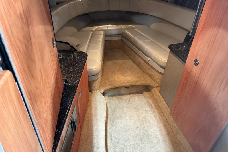 Slide: The Image of 2005 Formula 330 Sun Sport cabin interior with beige seating and wood accents. - 13