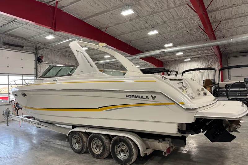 Slide: The Image of 2005 Formula 330 Sun Sport boat on trailer in indoor storage facility. - 3