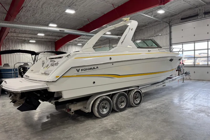 Slide: The Image of 2005 Formula 330 Sun Sport boat on trailer in indoor storage facility. - 4