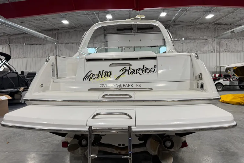 Slide: The Image of 2005 Formula 330 Sun Sport boat in a warehouse, rear view with "Gettin Started" text. - 6