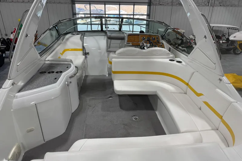 Slide: The Image of 2005 Formula 330 Sun Sport boat interior with white seating and yellow accents. - 7