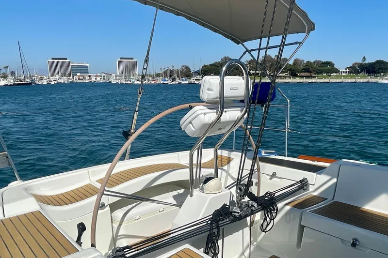 Slide: The Image of 2003 Beneteau First 47.7 sailboat cockpit with marina view in the background. - 15