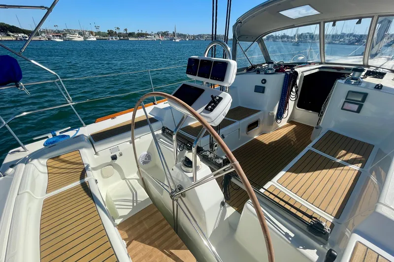 Slide: The Image of Cockpit of 2003 Beneteau First 47.7 sailboat with wooden deck and steering wheel. - 16