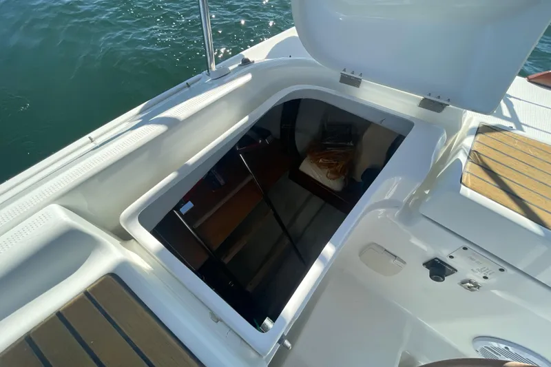 Slide: The Image of Open hatch on 2003 Beneteau First 47.7 sailboat, revealing interior storage space. - 19