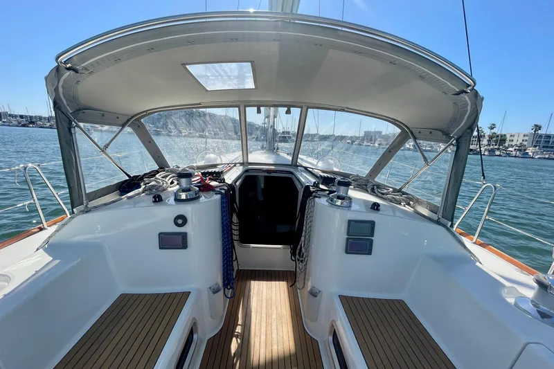 Slide: The Image of Cockpit view of 2003 Beneteau First 47.7 sailboat, featuring sleek design and marina backdrop. - 22