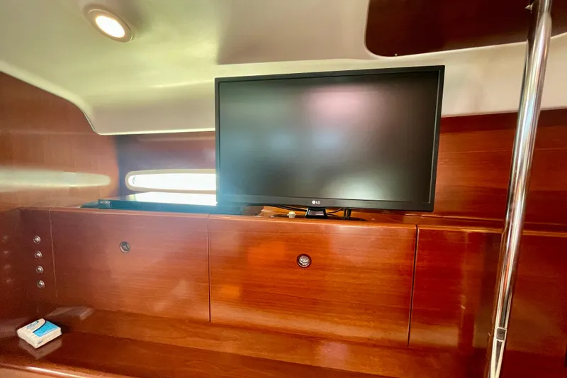 Slide: The Image of Interior of 2003 Beneteau First 47.7 yacht with TV and wooden cabinetry. - 29