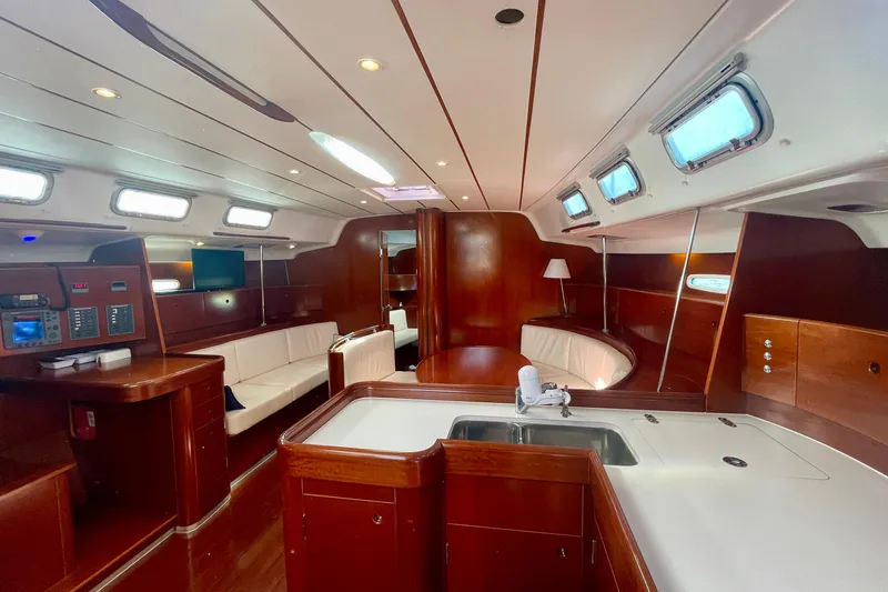 Slide: The Image of Luxurious interior of 2003 Beneteau First 47.7 yacht with elegant wood finish and seating. - 33