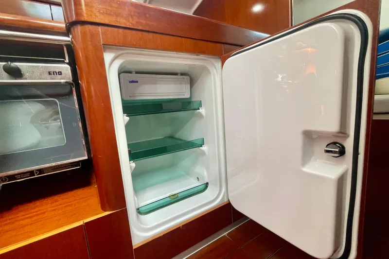 Slide: The Image of Open refrigerator in 2003 Beneteau First 47.7 yacht kitchen, showcasing interior shelves. - 36
