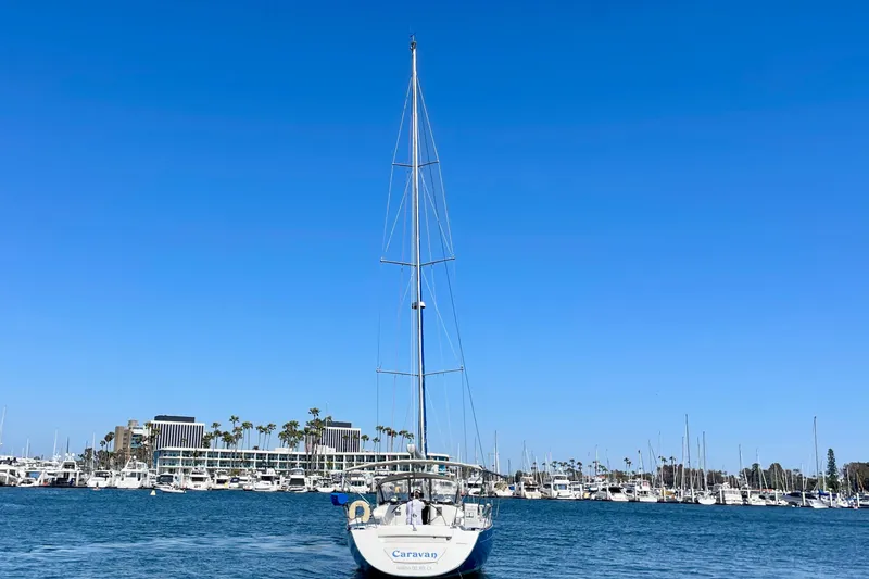 Slide: The Image of Sailboat Beneteau First 47.7 (2003) in marina, clear blue sky, waterfront buildings. - 4