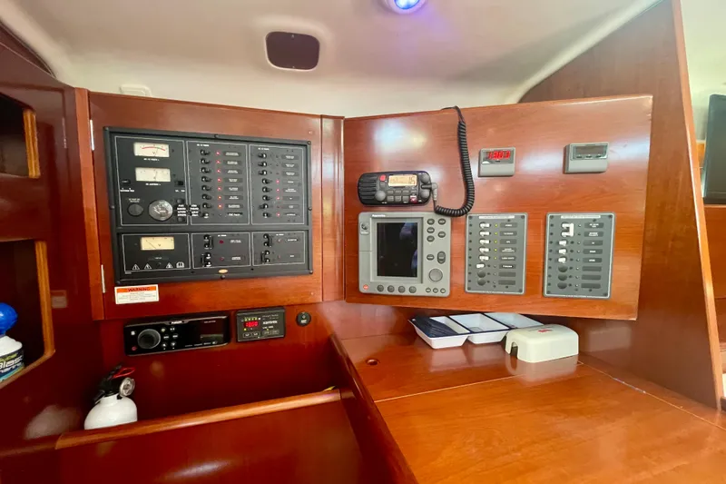 Slide: The Image of Control panel of a 2003 Beneteau First 47.7 yacht, featuring navigation and communication equipment. - 41