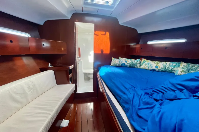 Slide: The Image of Luxurious cabin interior of 2003 Beneteau First 47.7 yacht with blue bedding. - 48