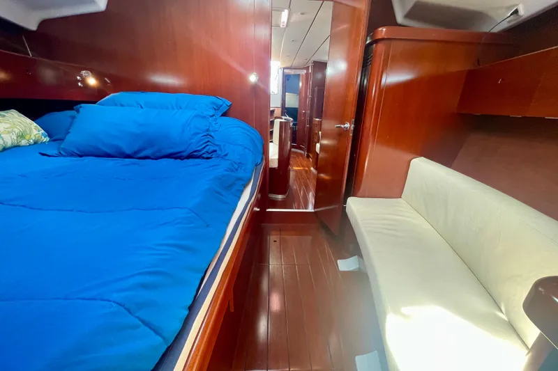 Slide: The Image of Luxurious cabin interior of 2003 Beneteau First 47.7 yacht with blue bedding. - 49