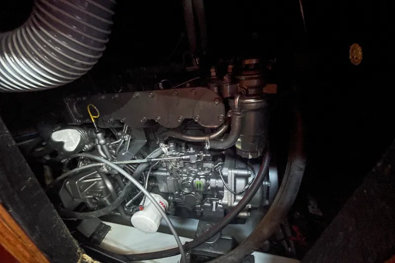 Slide: The Image of Engine compartment of a 2003 Beneteau First 47.7 sailboat, showcasing mechanical components. - 58