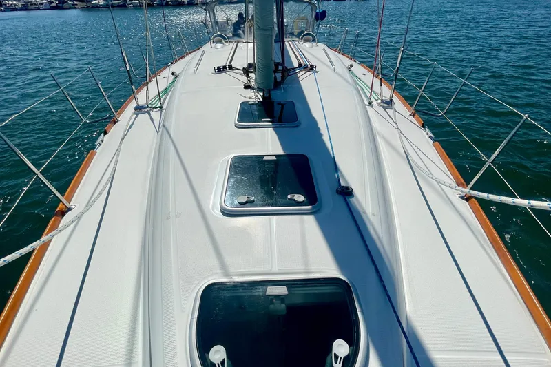 Slide: The Image of Beneteau First 47.7 sailboat deck, 2003 model, on calm water. - 8