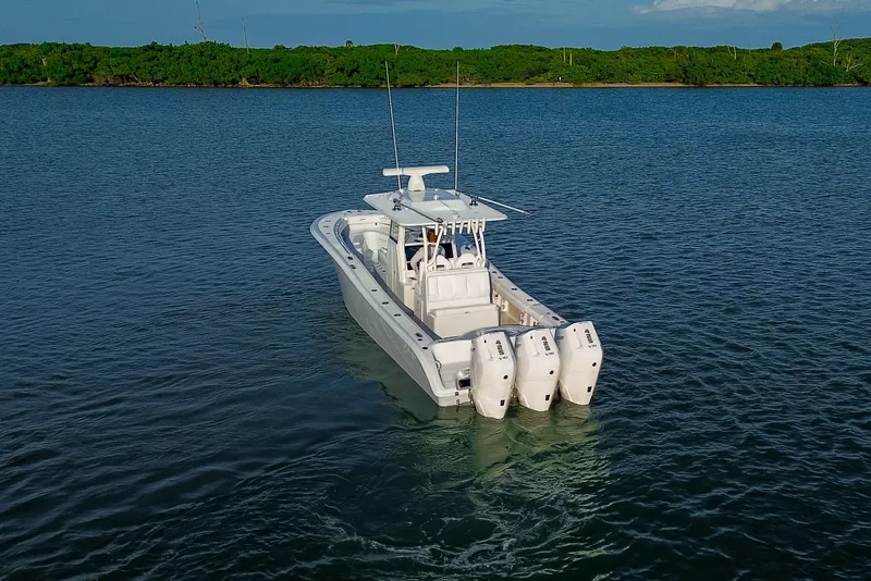 Slide: The Image of 2026 Yellowfin 36 Offshore boat with triple engines on calm water. - 100