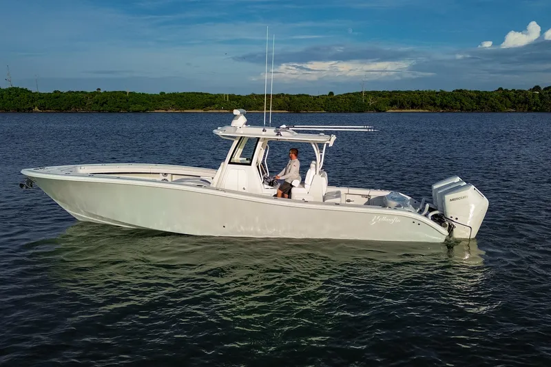 Slide: The Image of 2026 Yellowfin 36 Offshore boat on calm water, featuring sleek design and powerful engines. - 102