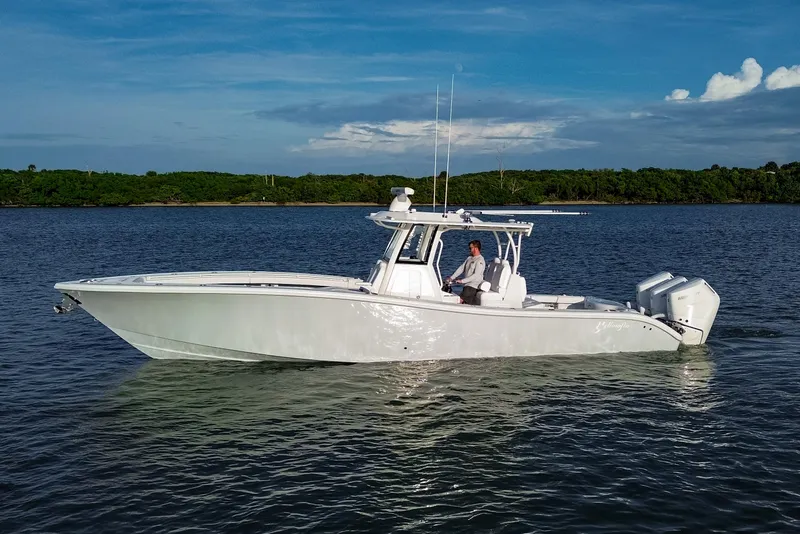 Slide: The Image of 2026 Yellowfin 36 Offshore boat cruising on calm waters under a clear blue sky. - 103