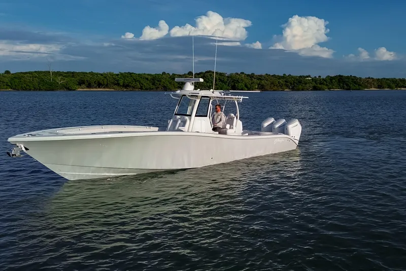Slide: The Image of 2026 Yellowfin 36 Offshore boat cruising on calm waters under a clear blue sky. - 104