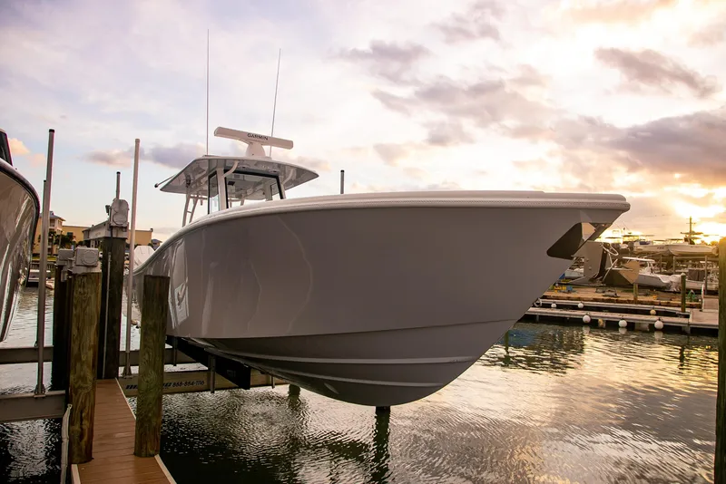 Slide: The Image of 2026 Yellowfin 36 Offshore boat docked at sunset, showcasing sleek design and modern features. - 113