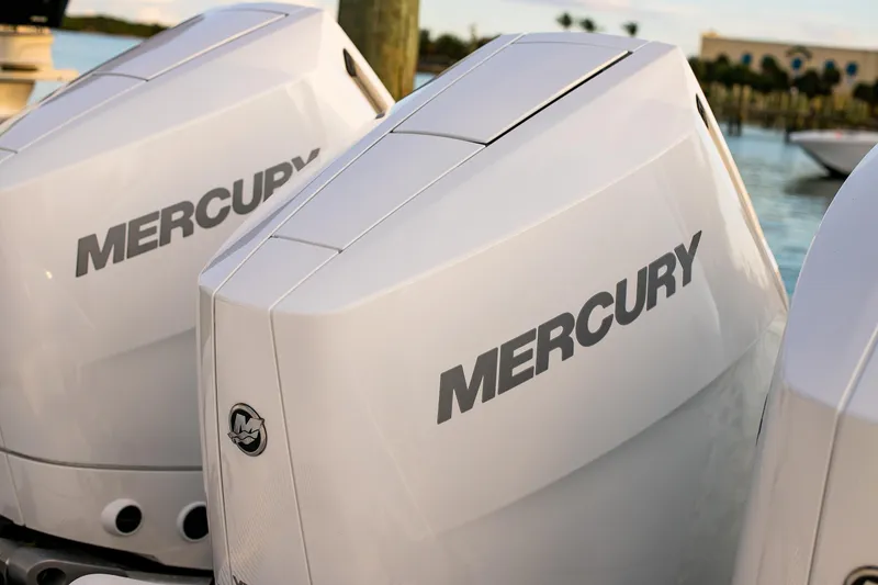 Slide: The Image of Twin Mercury outboard engines on a 2026 Yellowfin 36 Offshore boat, docked by the water. - 120