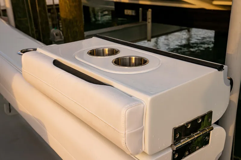 Slide: The Image of 2026 Yellowfin 36 Offshore boat with dual cup holders on white cushioned seat. - 127