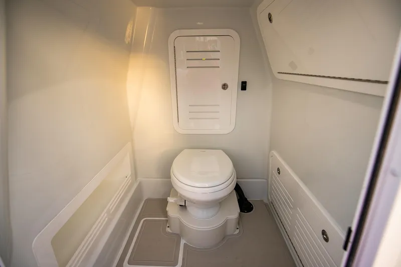 Slide: The Image of 2026 Yellowfin 36 Offshore boat interior bathroom with modern design and compact toilet. - 128