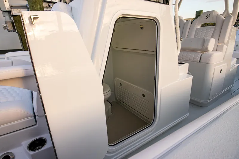 Slide: The Image of 2026 Yellowfin 36 Offshore boat interior with open cabin door and seating. - 129