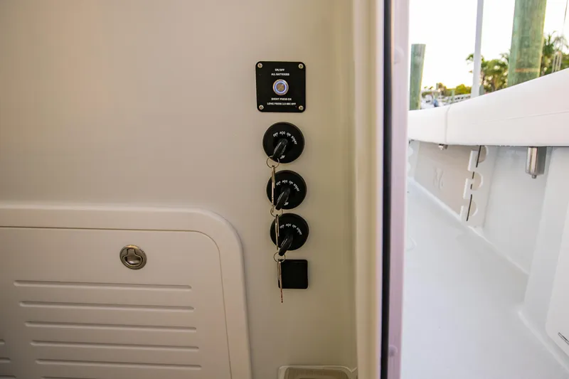 Slide: The Image of 2026 Yellowfin 36 Offshore boat control panel with ignition keys and switches. - 130