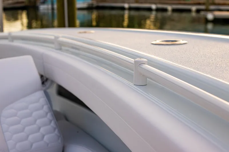 Slide: The Image of 2026 Yellowfin 36 Offshore boat interior with sleek white seating and railing. - 139