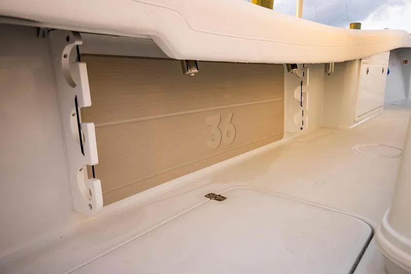 Slide: The Image of 2026 Yellowfin 36 Offshore boat interior detail, showcasing storage compartment and deck design. - 149
