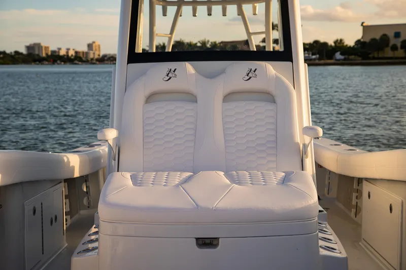 Slide: The Image of 2026 Yellowfin 36 Offshore boat with luxurious white seating, docked by the water. - 152