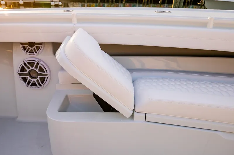 Slide: The Image of 2026 Yellowfin 36 Offshore boat with white cushioned seating and built-in speakers. - 166