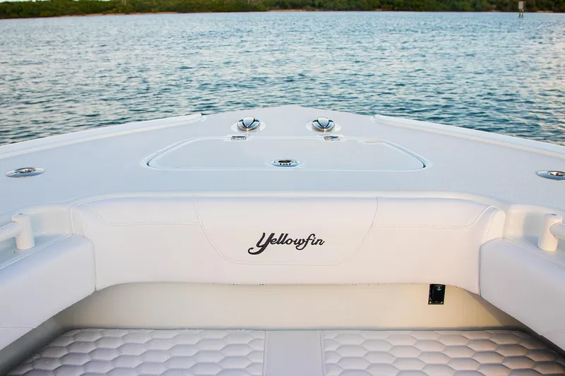Slide: The Image of 2026 Yellowfin 36 Offshore boat interior with white seating, on calm water. - 172