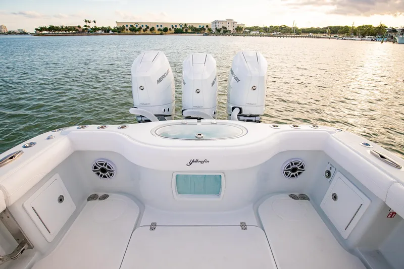 Slide: The Image of 2026 Yellowfin 36 Offshore boat with triple Mercury engines on calm water. - 19