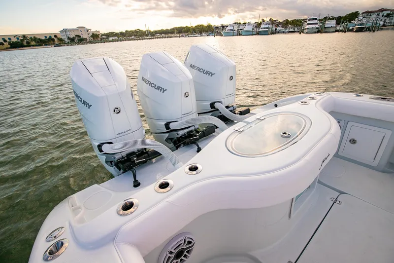 Slide: The Image of 2026 Yellowfin 36 Offshore boat with triple Mercury engines on calm water. - 20