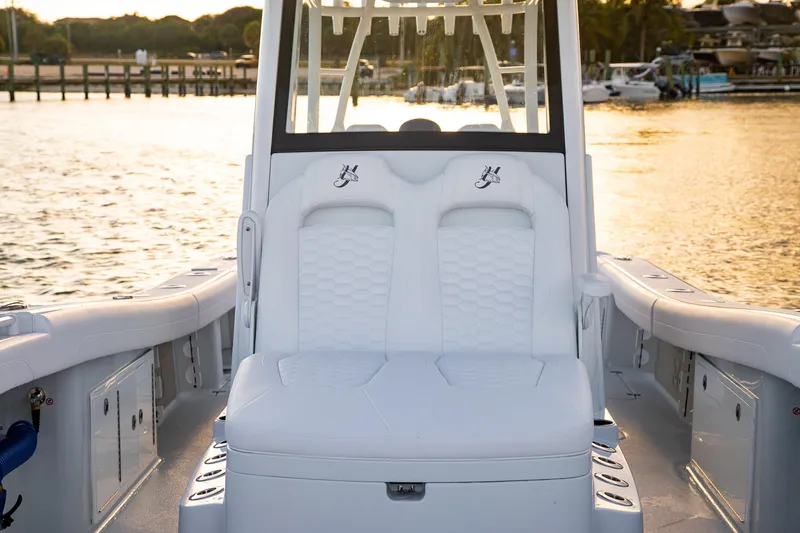 Slide: The Image of 2026 Yellowfin 36 Offshore boat interior with white seating at sunset. - 34