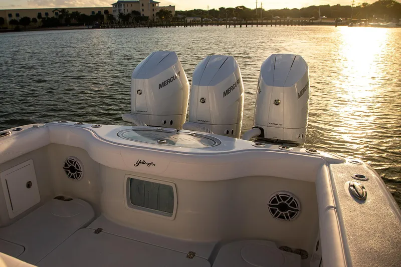 Slide: The Image of 2026 Yellowfin 36 Offshore boat with triple Mercury engines at sunset on the water. - 4